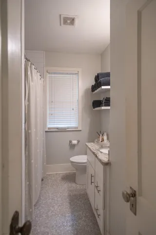 a bathroom with a sink toilet and a mirror