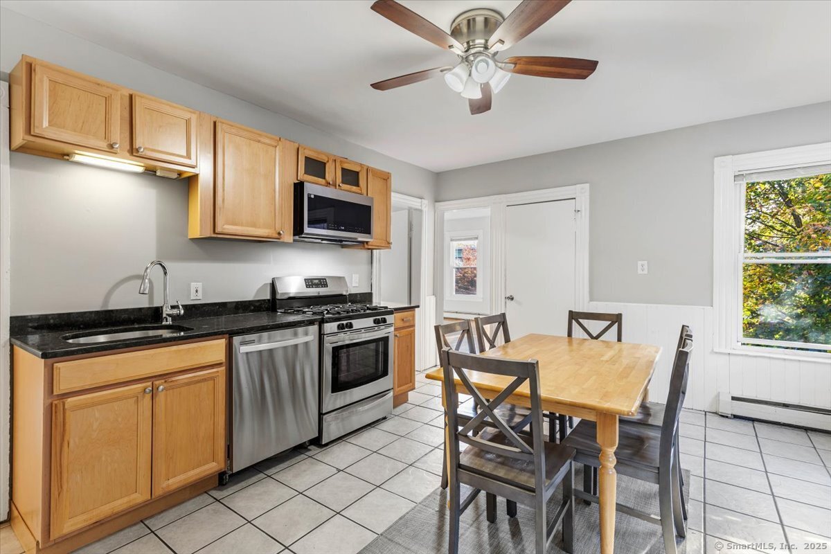 136 Nash Street New Haven, CT 06511 - Photo 3 of 10 a view of a kitchen with granite countertop a stove top oven a sink a dining table and chairs