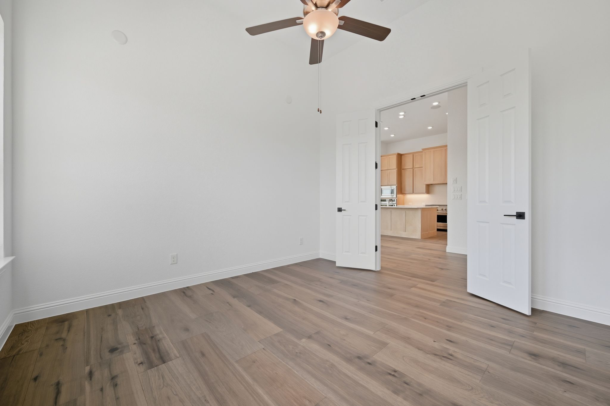 216 Moria Court Georgetown, TX 78628 - Photo 11 of 30 Unfurnished room with light wood-style flooring, recessed lighting, and a ceiling fan