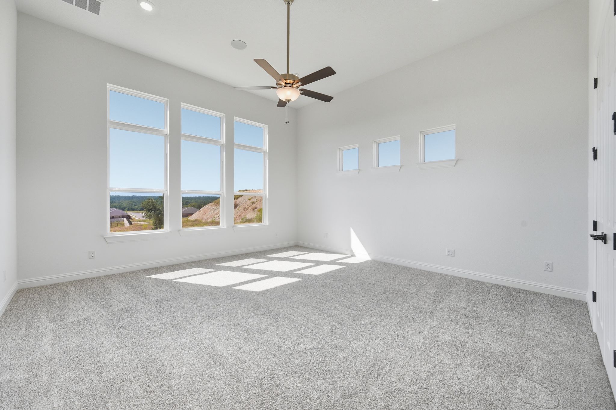 216 Moria Court Georgetown, TX 78628 - Photo 13 of 30 Spare room featuring plenty of natural light, light carpet, a ceiling fan, and recessed lighting