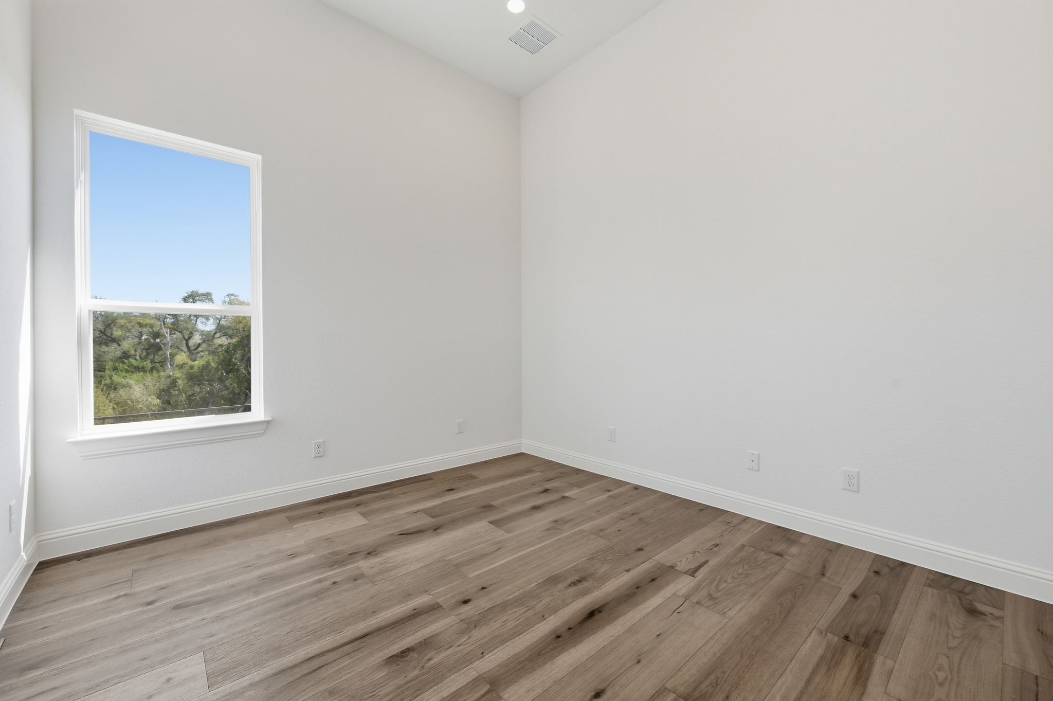 216 Moria Court Georgetown, TX 78628 - Photo 21 of 30 Empty room featuring light wood-type flooring and recessed lighting