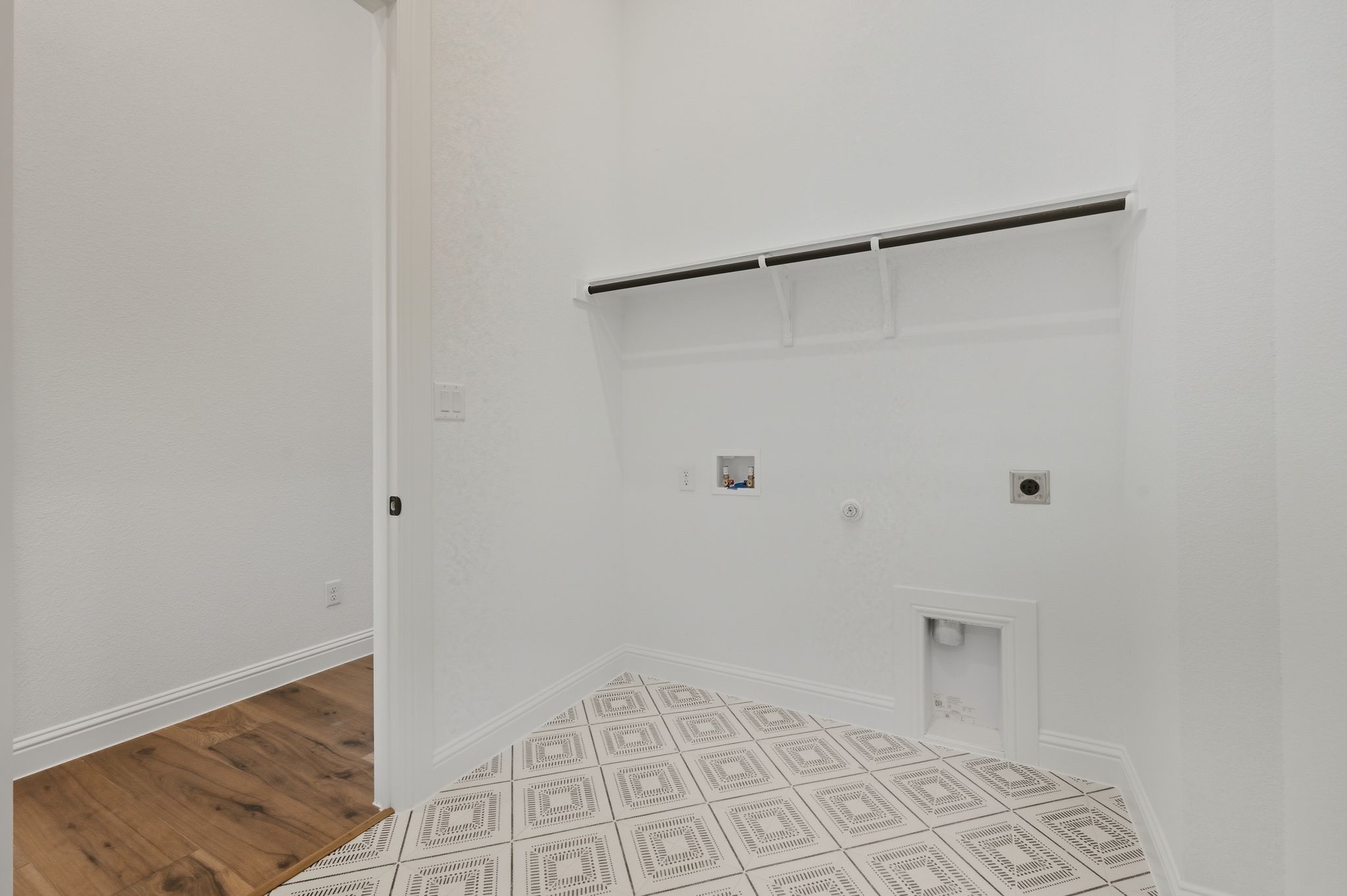 216 Moria Court Georgetown, TX 78628 - Photo 24 of 30 Laundry room featuring gas dryer hookup, electric dryer hookup, hookup for a washing machine, and light wood finished floors