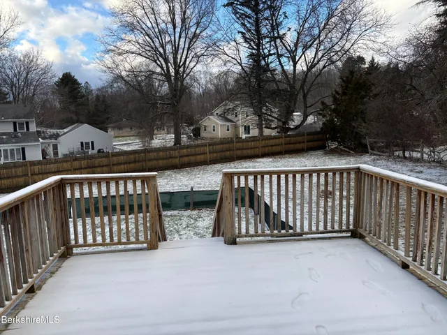 a kitchen with stainless steel appliances granite countertop a refrigerator a sink a stove a microwave and wooden cabinets