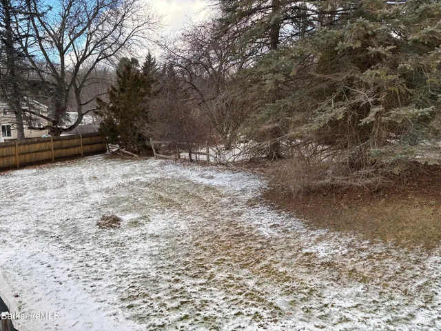 a kitchen with wooden cabinets and stainless steel appliances