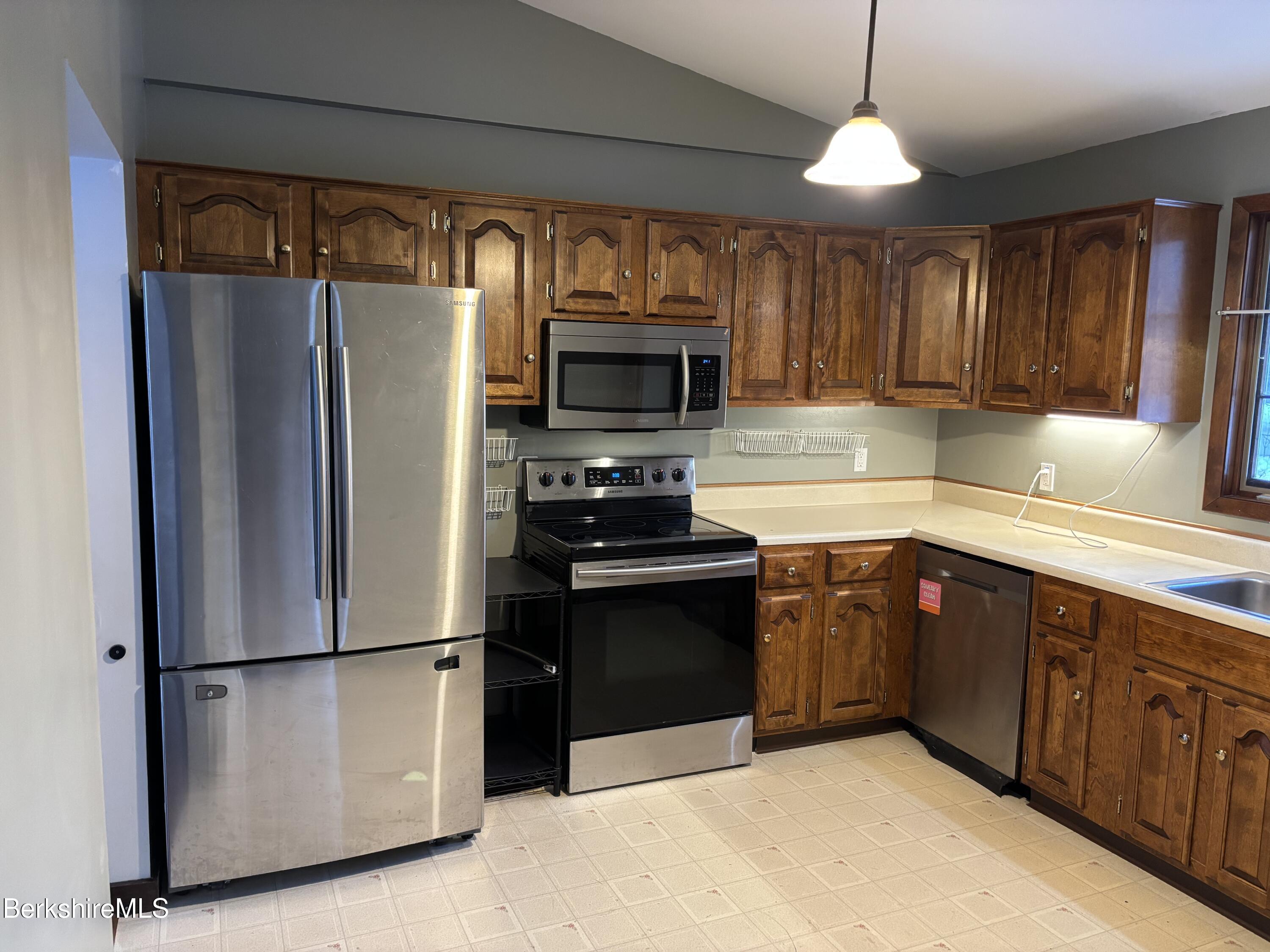 39 Barton Hill Road Dalton, MA 01226 - Photo 9 of 38 a kitchen with stainless steel appliances granite countertop a refrigerator a sink a stove a microwave and wooden cabinets