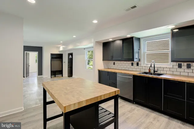 a large kitchen with kitchen island a sink counter space and appliances