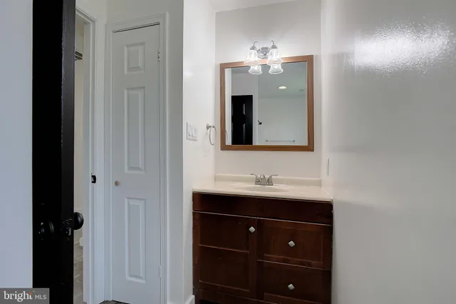 a bathroom with a double vanity sink and mirror