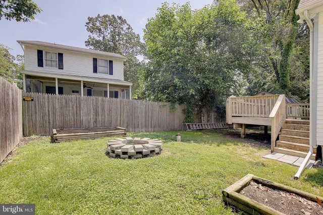 a backyard of a house with barbeque oven and outdoor seating