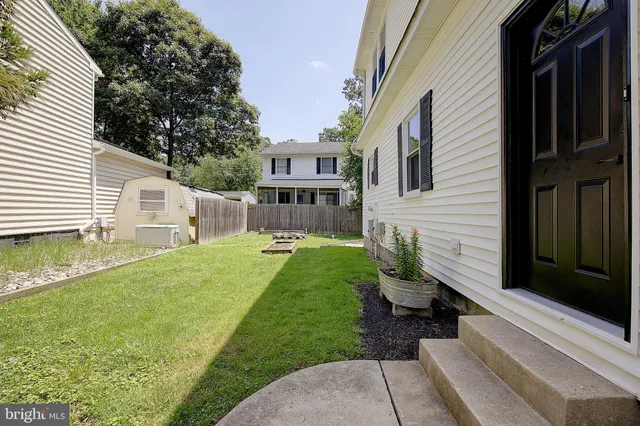 a view of a house with a yard and sitting area