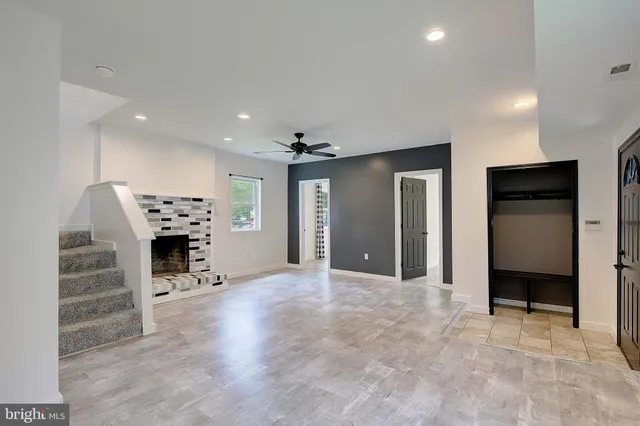 an empty room with furniture and a fireplace