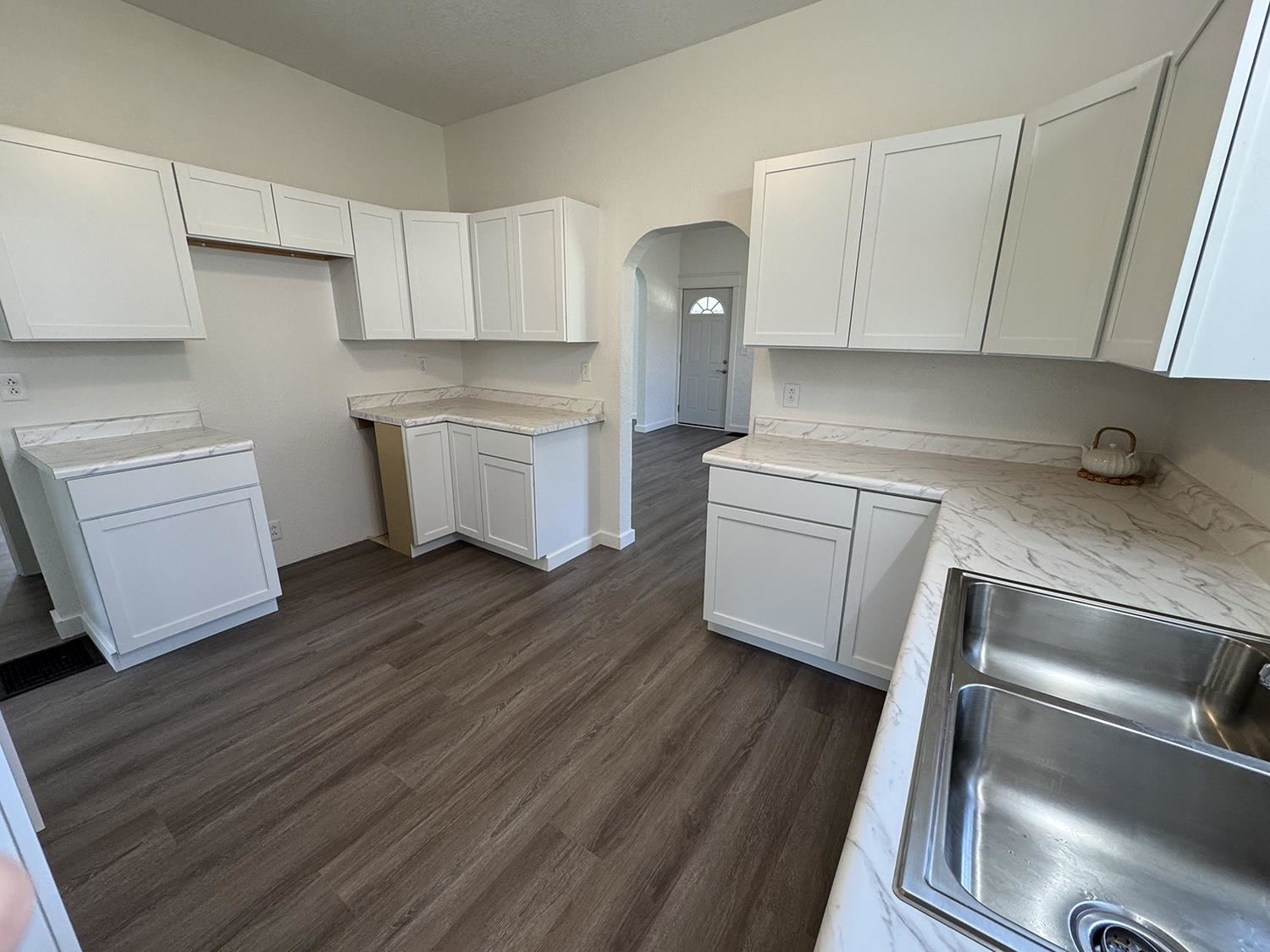 101 East Division Road Shannon, IL 61078 - Photo 14 of 52 a kitchen with a refrigerator sink and cabinets
