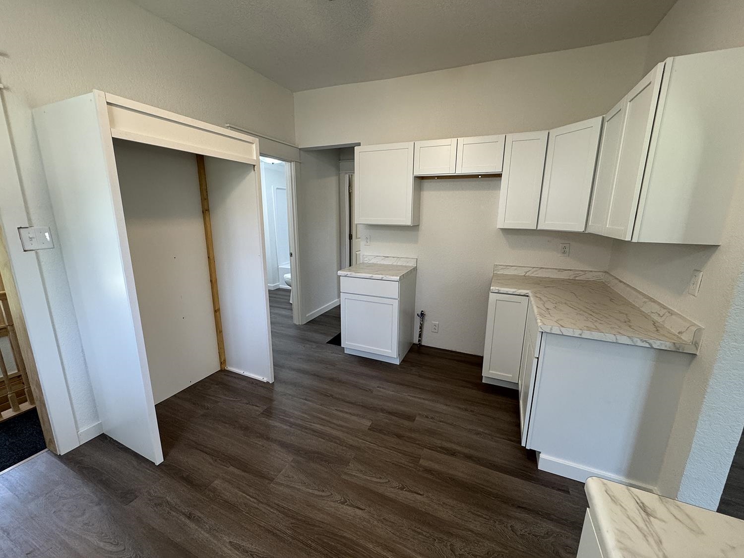 101 East Division Road Shannon, IL 61078 - Photo 15 of 52 a view of a kitchen with wooden floor and electronic appliances