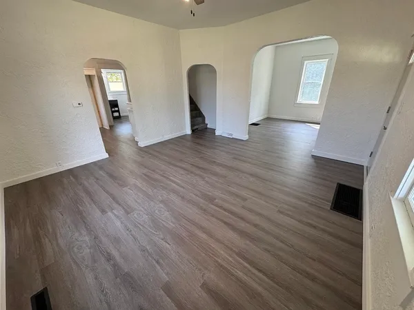 wooden floor in an empty room with a window