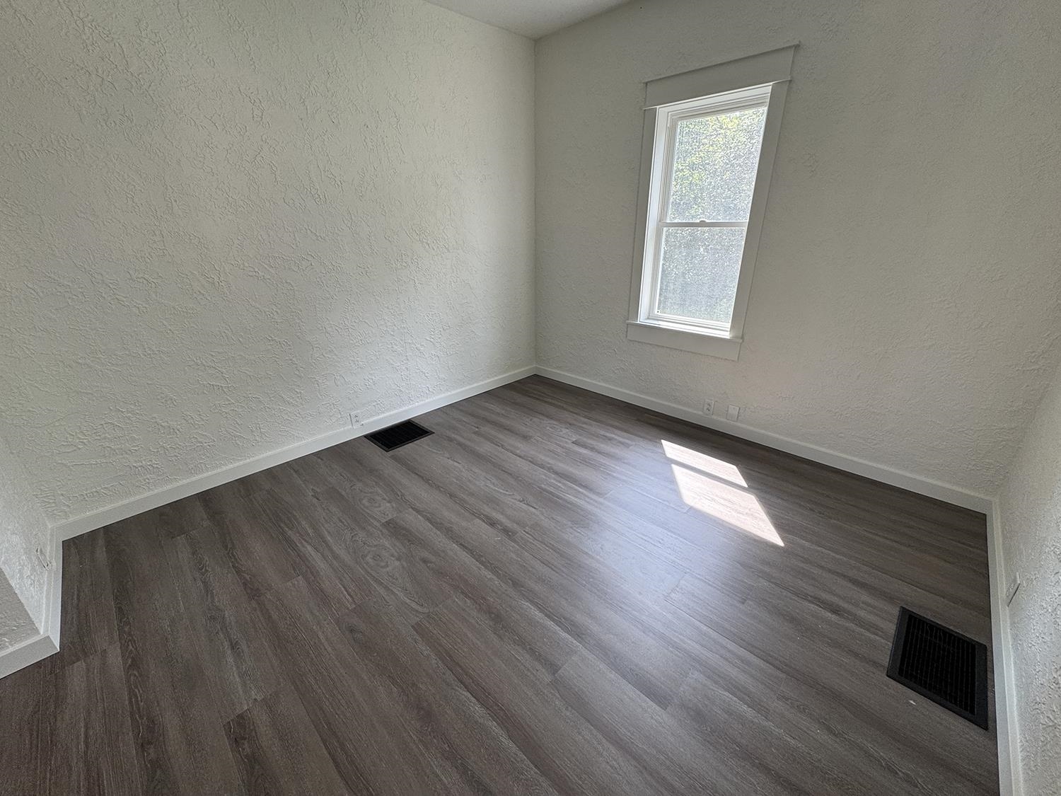 101 East Division Road Shannon, IL 61078 - Photo 23 of 52 a view of an empty room with wooden floor and a window