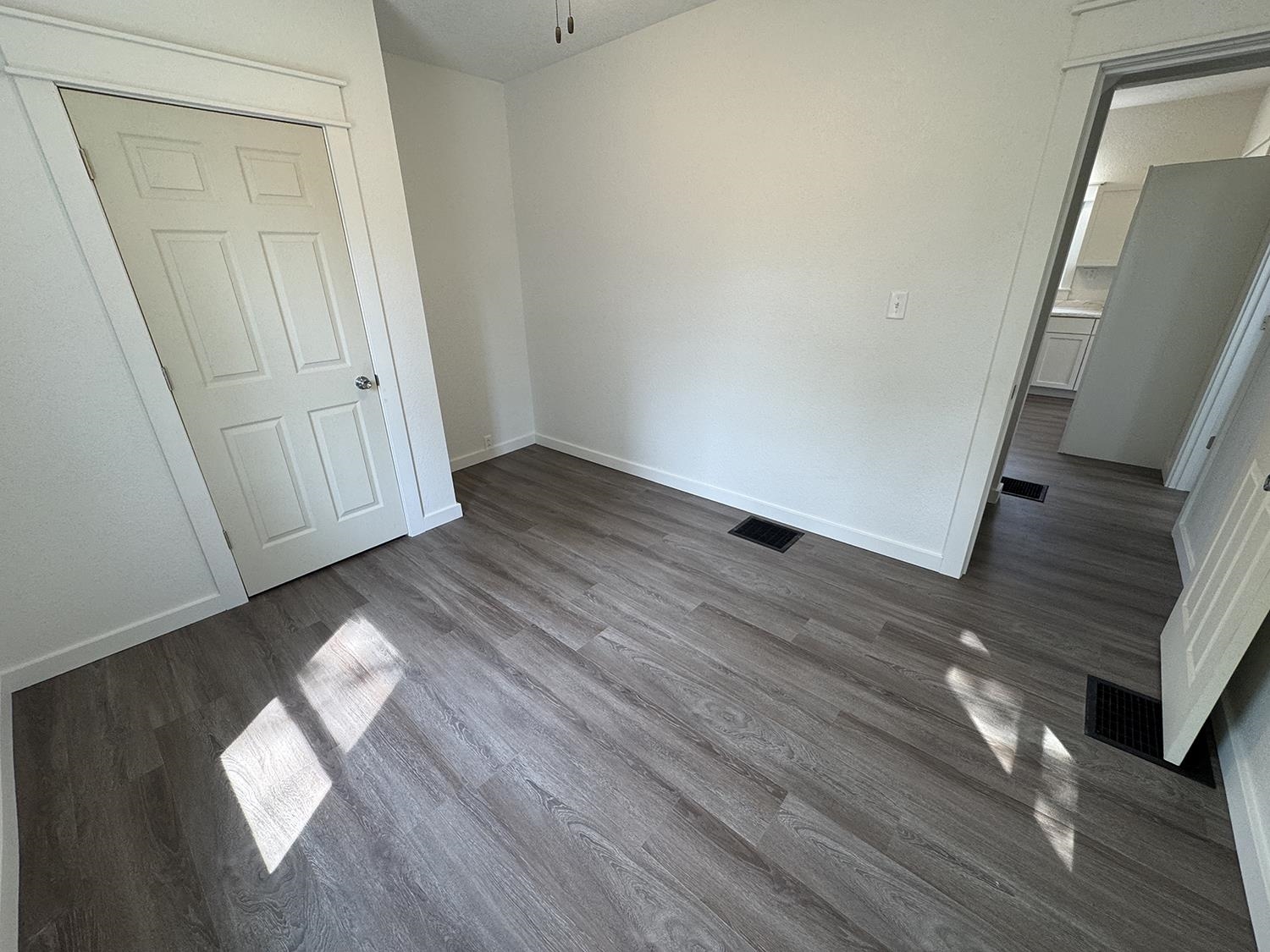 101 East Division Road Shannon, IL 61078 - Photo 28 of 52 an empty room with wooden floor and windows