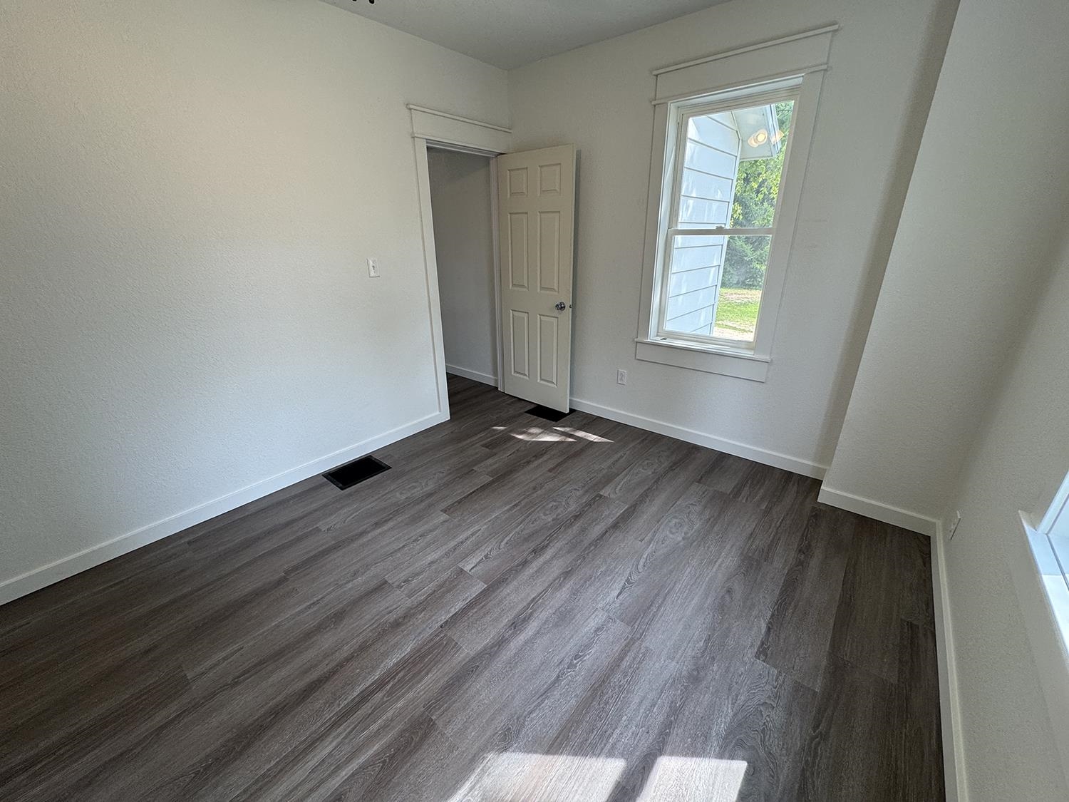101 East Division Road Shannon, IL 61078 - Photo 29 of 52 an empty room with wooden floor and windows