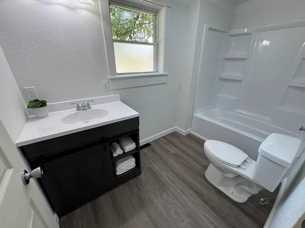 a bathroom with a sink toilet and vanity