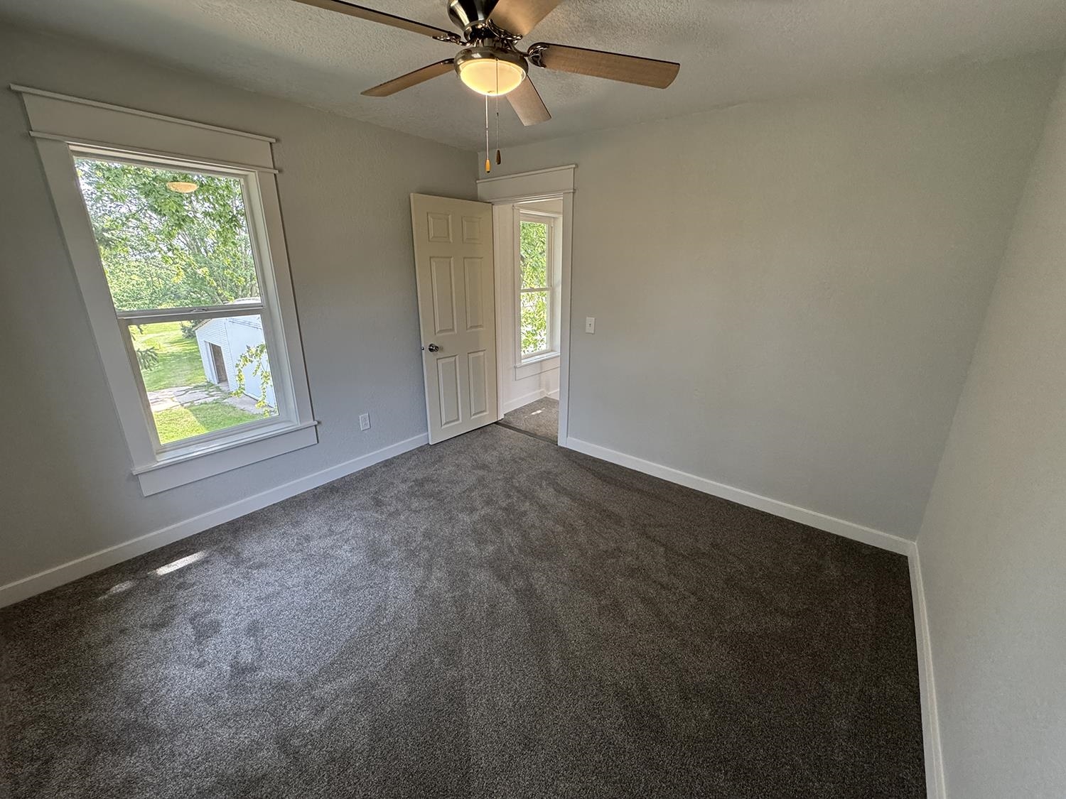 101 East Division Road Shannon, IL 61078 - Photo 38 of 52 an empty room with windows and fan