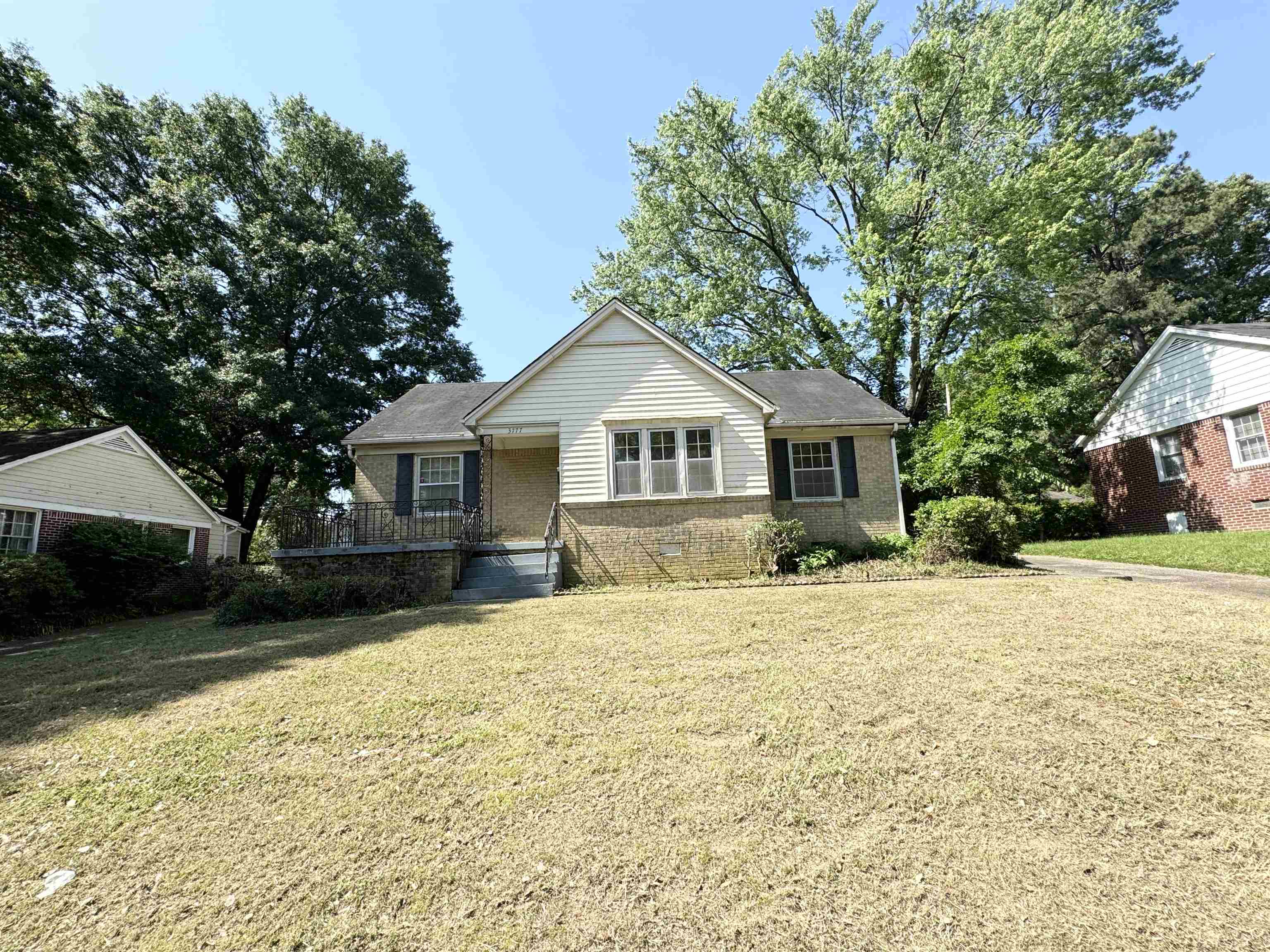 a front view of house with yard and trees