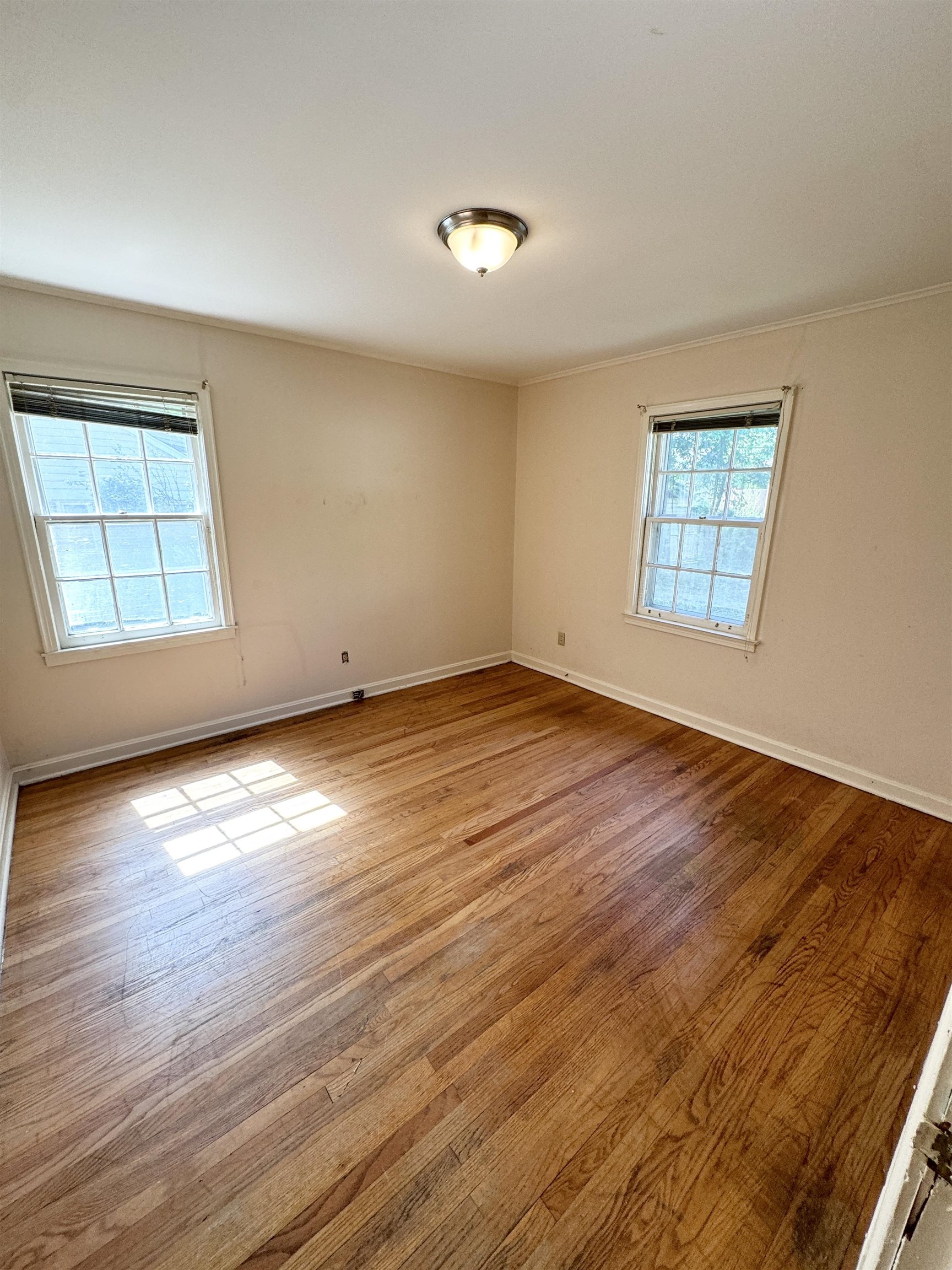 3777 Healey Road Memphis, TN 38111 - Photo 11 of 15 an empty room with wooden floor and windows