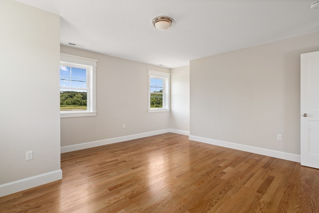 70 Depot Road Hatfield, MA 01038 - Photo 40 of 42 an empty room with wooden floor and windows