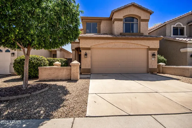 a front view of a house with garage
