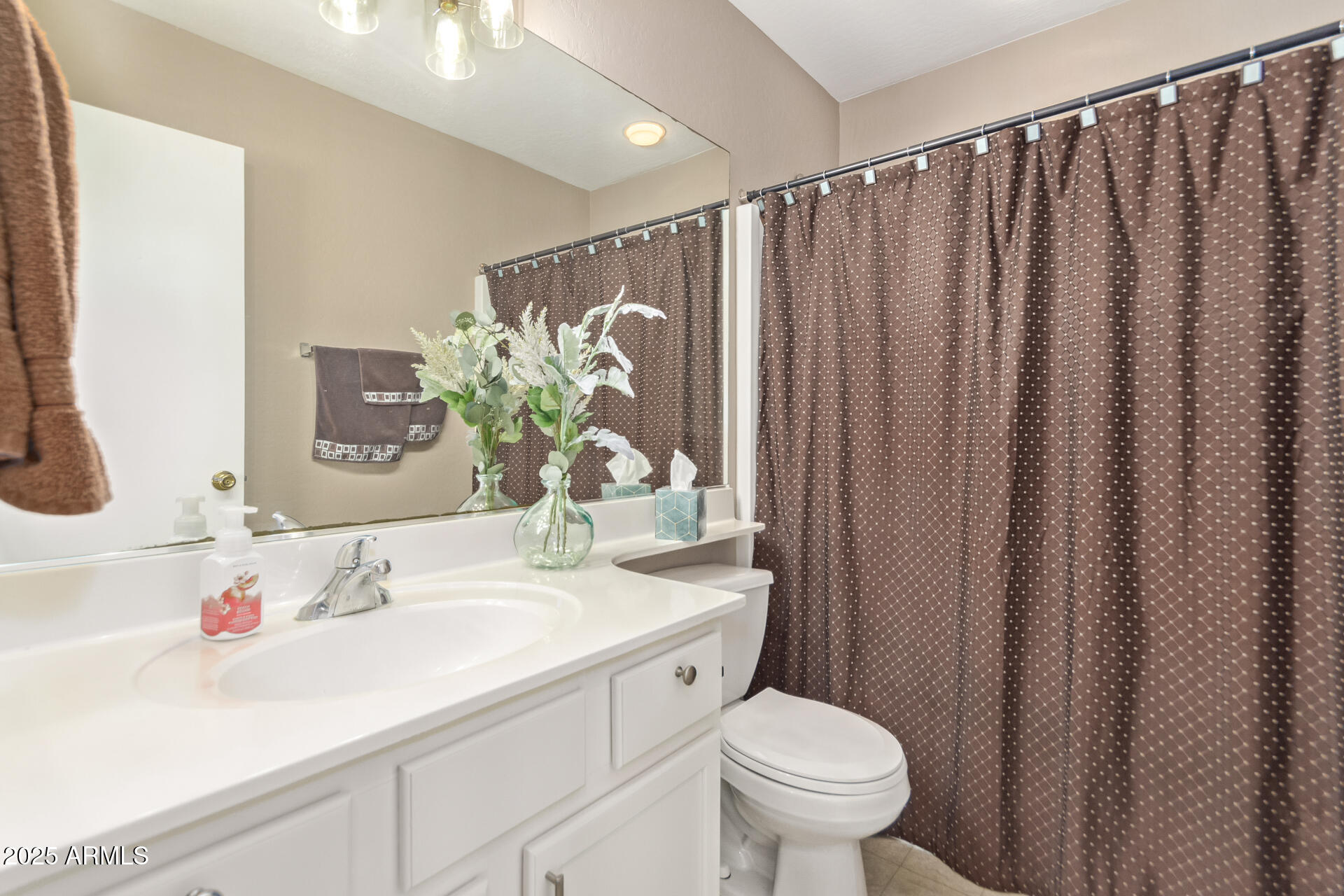 10521 West Berkeley Road Avondale, AZ 85392 - Photo 12 of 21 a bathroom with a sink a toilet and a mirror