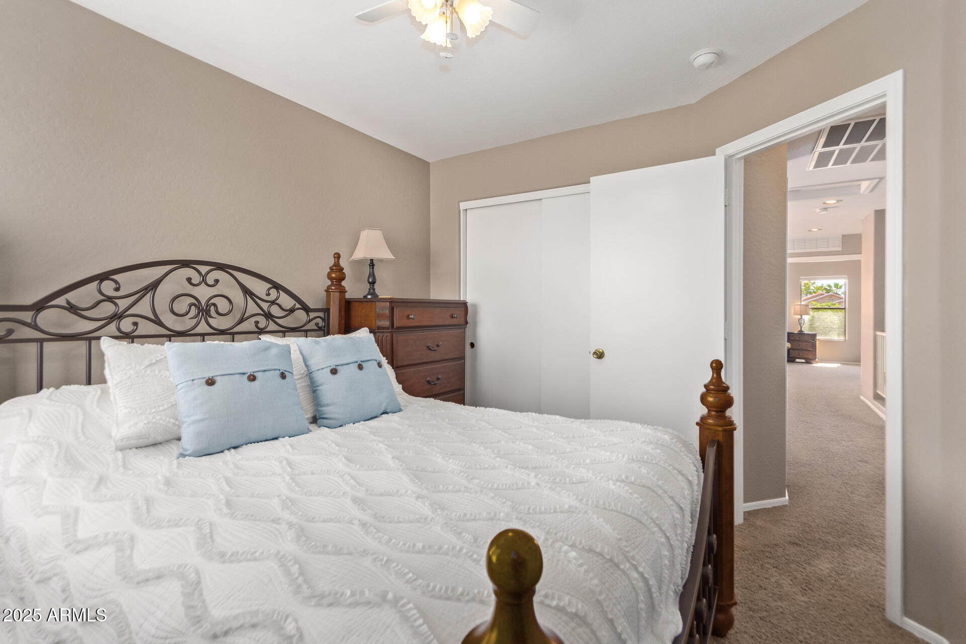 10521 West Berkeley Road Avondale, AZ 85392 - Photo 15 of 21 a bedroom with a bed and a chandelier