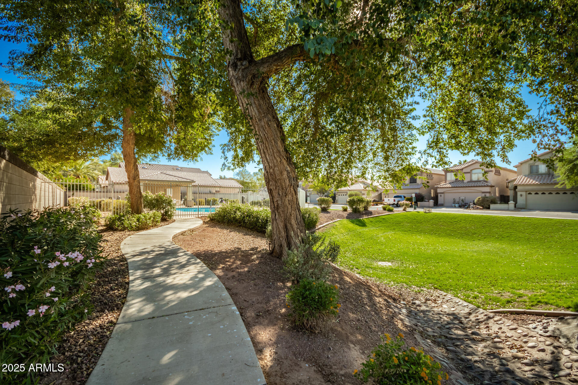 10521 West Berkeley Road Avondale, AZ 85392 - Photo 20 of 21 a front view of a house with a garden and trees
