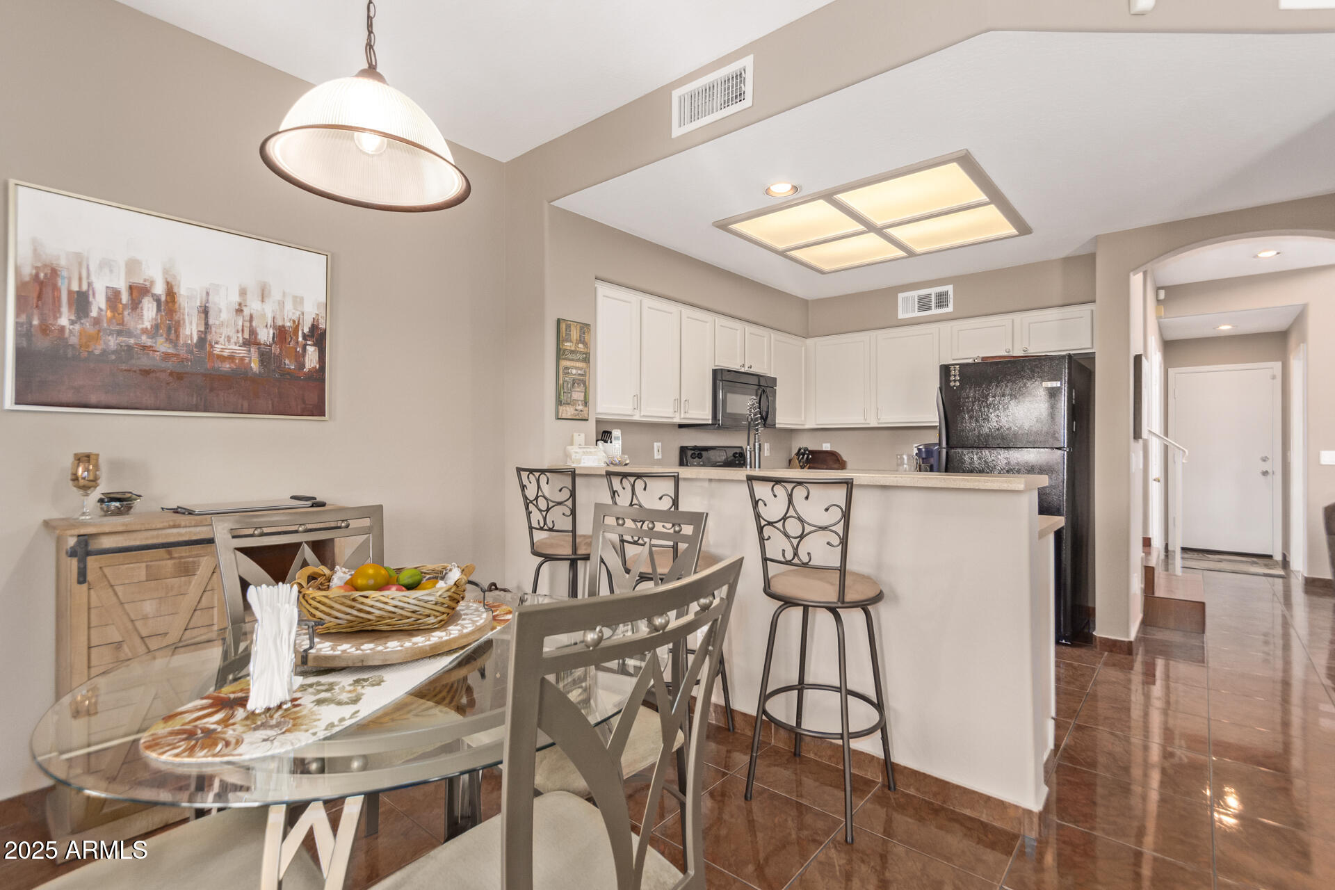 10521 West Berkeley Road Avondale, AZ 85392 - Photo 5 of 21 a kitchen with stainless steel appliances kitchen island granite countertop a refrigerator and microwave