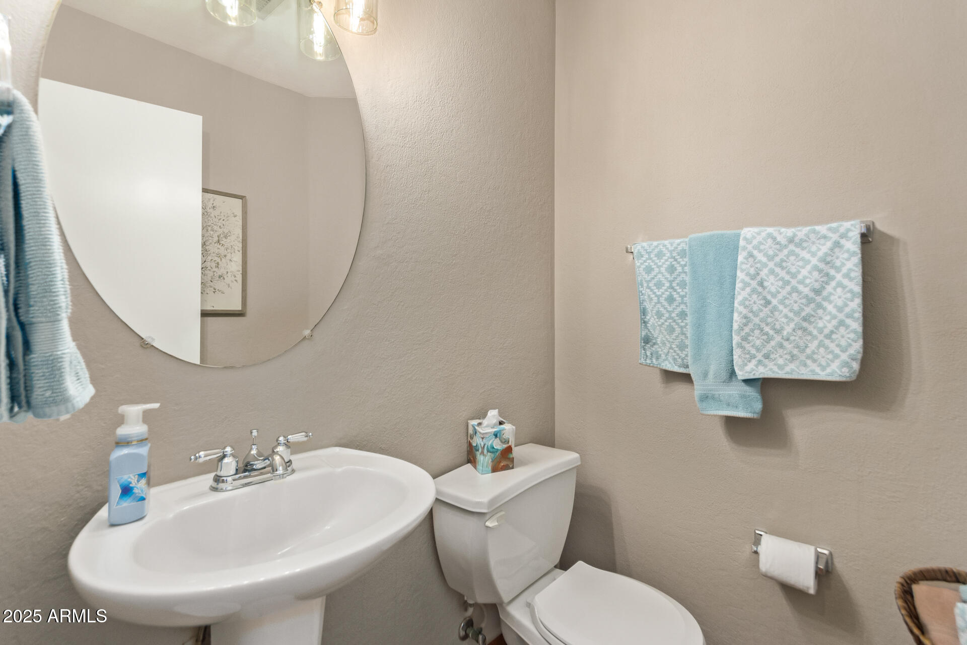 10521 West Berkeley Road Avondale, AZ 85392 - Photo 10 of 21 a bathroom with a toilet a sink and mirror