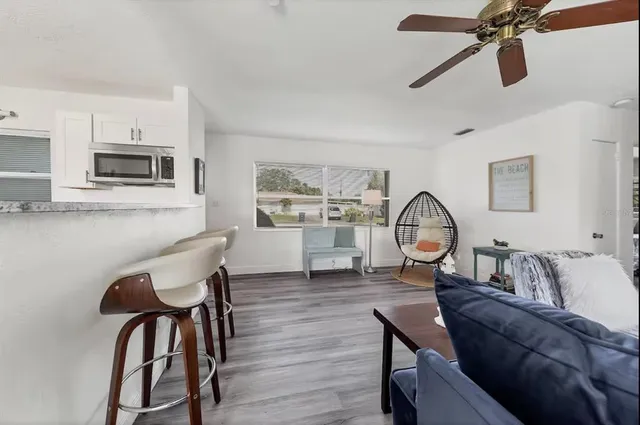 a living room with furniture a window and a flat screen tv