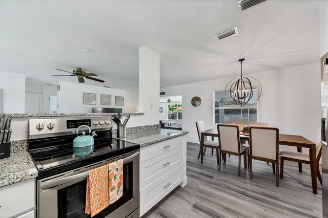a kitchen with granite countertop counter space a sink appliances and cabinets