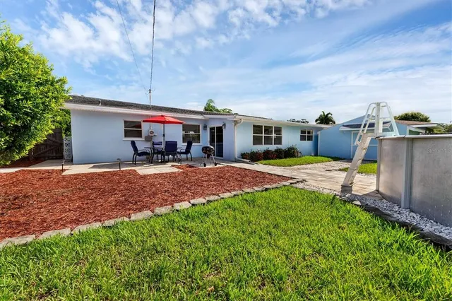 a view of a house with backyard porch and sitting area