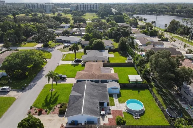 an aerial view of residential space with swimming pool outdoor seating and yard