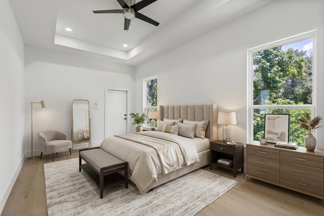 7319 Laura Koppe Road Houston, TX 77028 - Photo 17 of 42 Spacious and elegant bedroom featuring a plush bed, modern furniture, and large windows that fill the space with natural light and offer serene views.