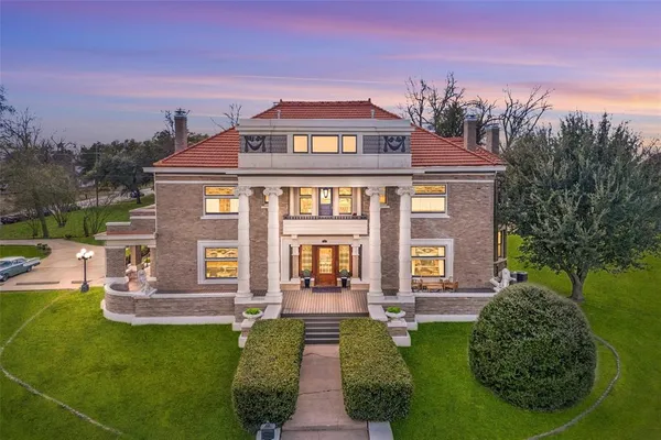a front view of a house with garden