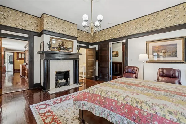 a spacious bedroom with a bed and a fireplace