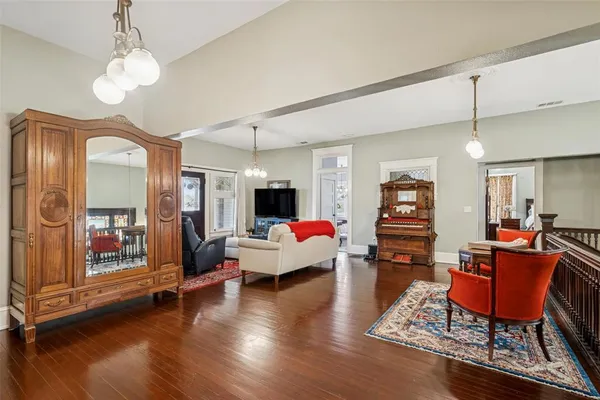 a living room with furniture and wooden floor