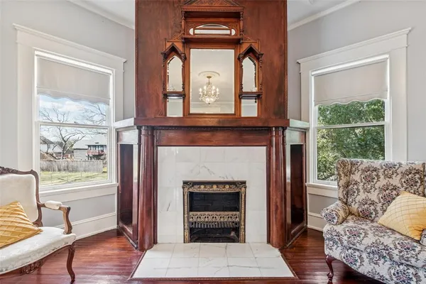 a living room with furniture a window and a fireplace
