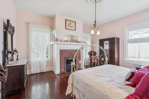 a bedroom with a bed and a fireplace
