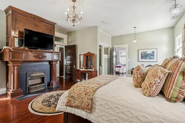 a spacious bedroom with a bed and a flat screen tv