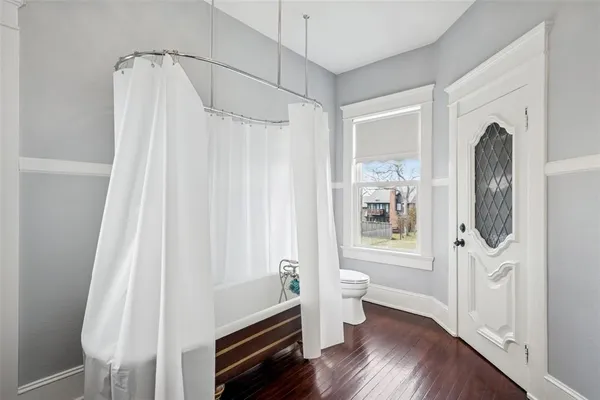 a bathroom with a toilet a sink and shower