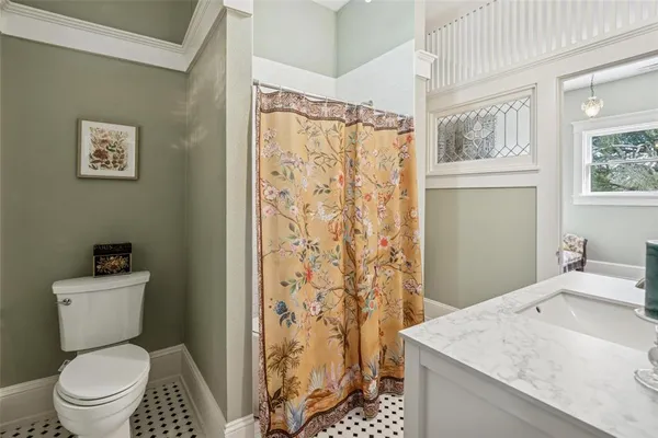 a bathroom with a granite countertop sink toilet and shower