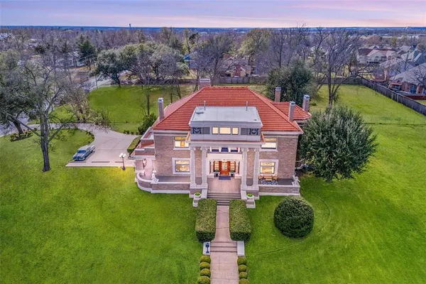 a aerial view of a house with a garden and a yard