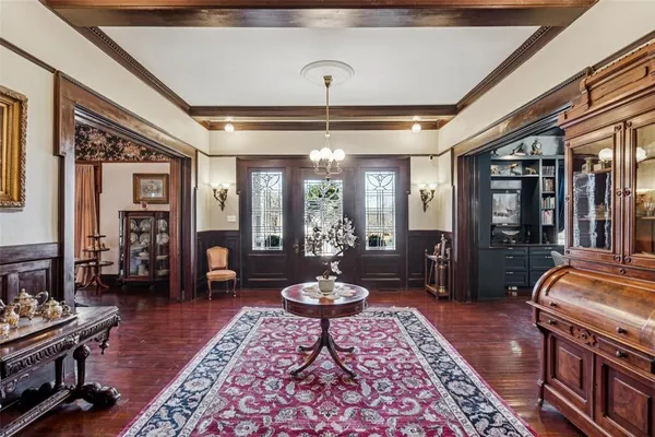 a living room with furniture a rug and a chandelier