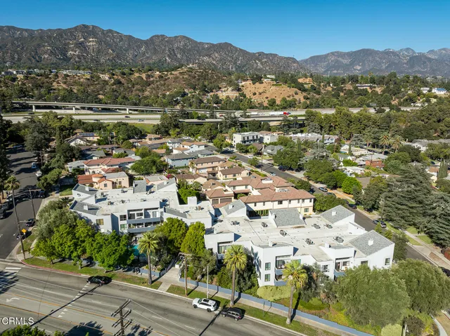 a view of a kitchen with a sink and refrigerator