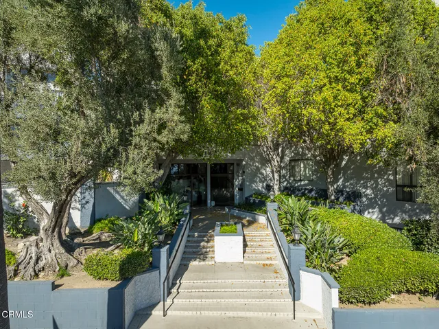a kitchen with stainless steel appliances a stove a refrigerator and cabinets