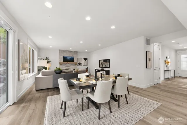 a view of a dining room with furniture window and wooden floor