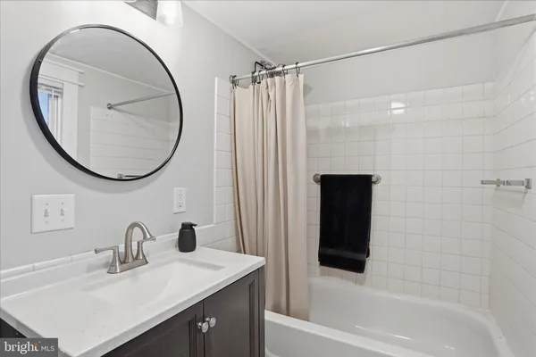 a bathroom with a sink vanity toilet and a mirror